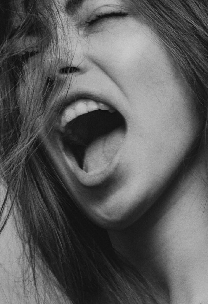 grayscale photography of a woman screaming